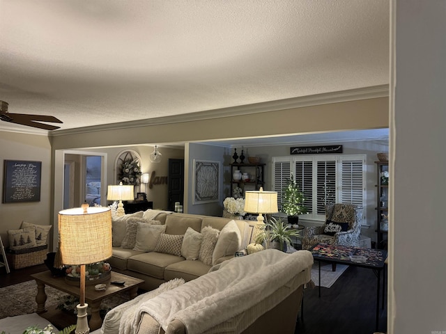 living room with ornamental molding, a ceiling fan, a textured ceiling, and wood finished floors