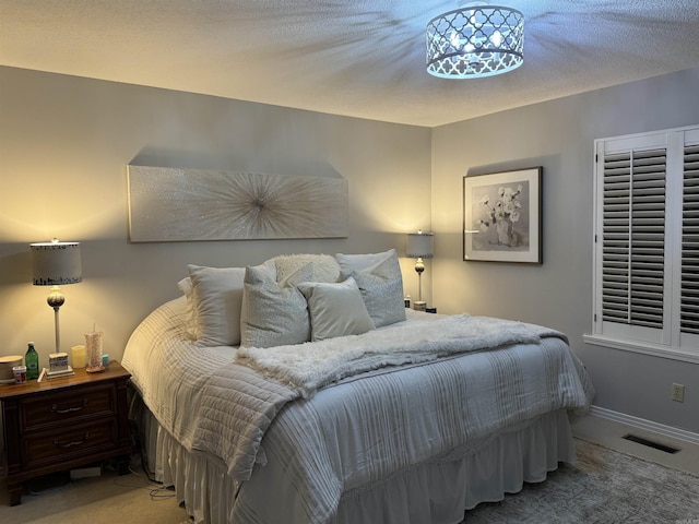 bedroom with carpet, visible vents, and baseboards