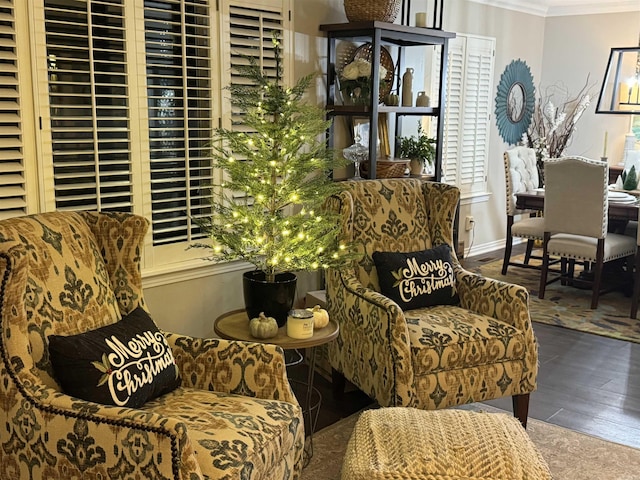 sitting room with dark wood-style floors, baseboards, and ornamental molding