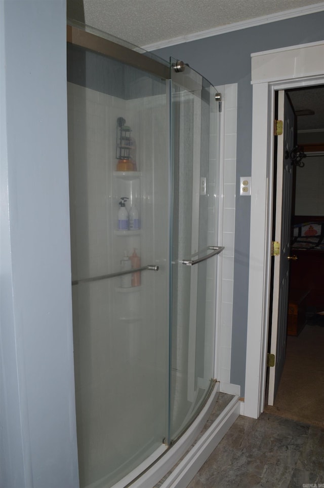 bathroom with a stall shower and a textured ceiling