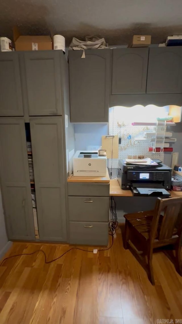 kitchen with light wood finished floors and gray cabinetry