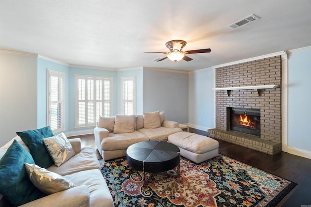 living room featuring ornamental molding, wood finished floors, and visible vents