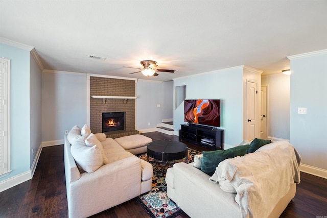 living room with a brick fireplace, dark wood-style flooring, crown molding, and baseboards