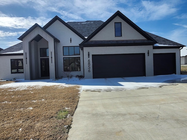 view of front of house featuring an attached garage and brick siding