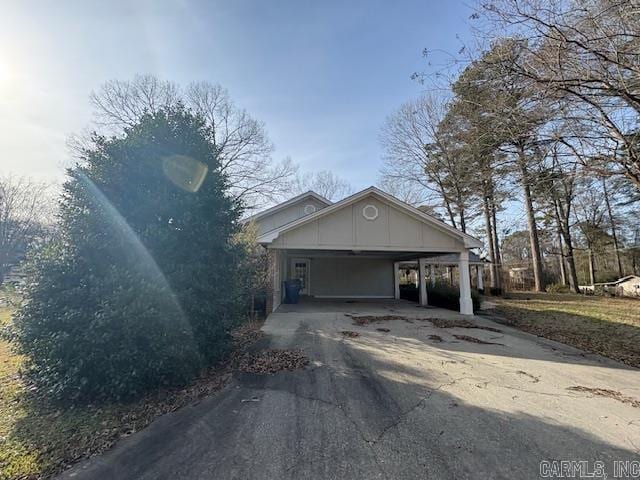 view of front of home with aphalt driveway and a carport