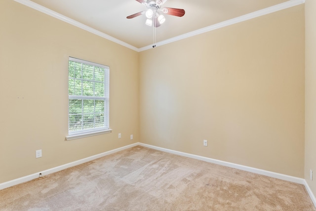 spare room featuring ornamental molding, light colored carpet, and baseboards