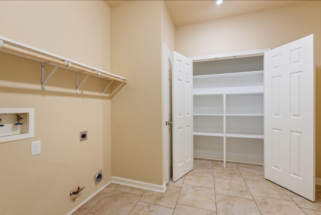 washroom featuring gas dryer hookup, hookup for a washing machine, hookup for an electric dryer, laundry area, and baseboards