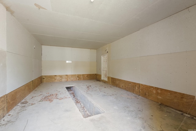 unfurnished room with concrete flooring