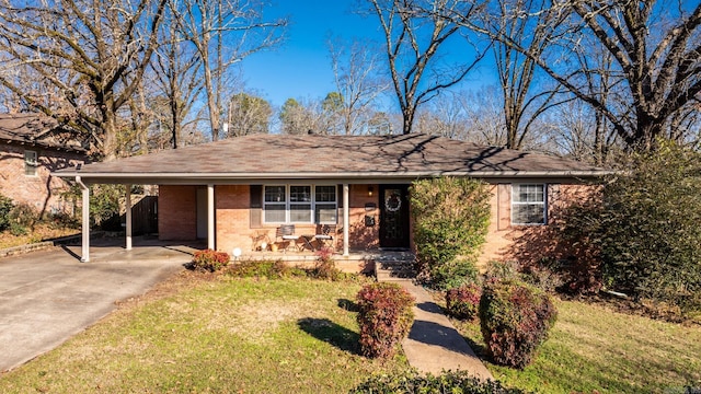 single story home with brick siding, covered porch, a carport, driveway, and a front lawn