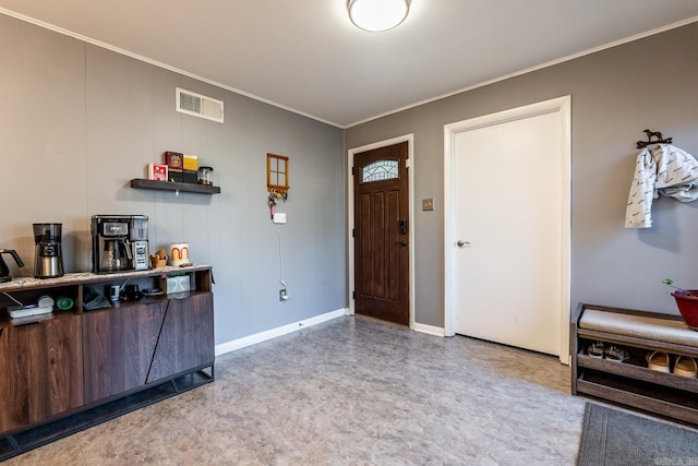 entrance foyer featuring ornamental molding, visible vents, baseboards, and light floors