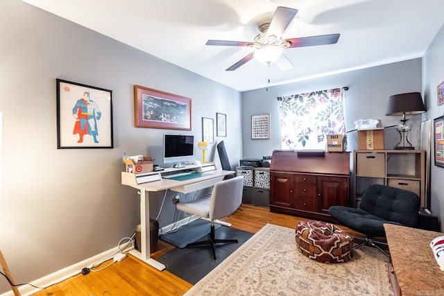 office area with ceiling fan, baseboards, and wood finished floors