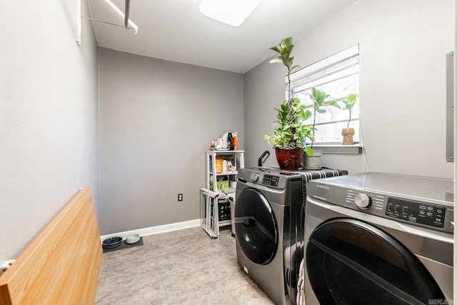 laundry room with laundry area, baseboards, and separate washer and dryer