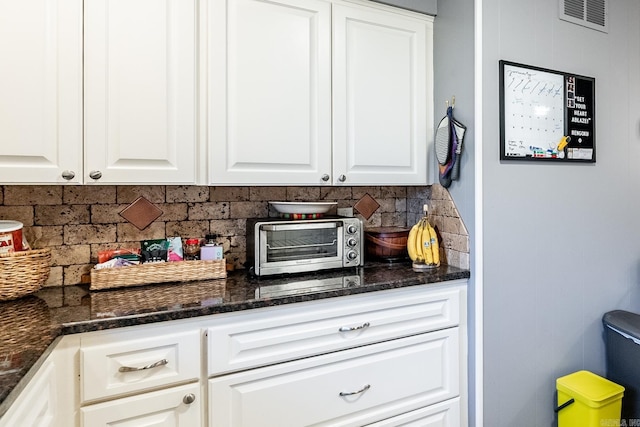 bar featuring a toaster, visible vents, and decorative backsplash