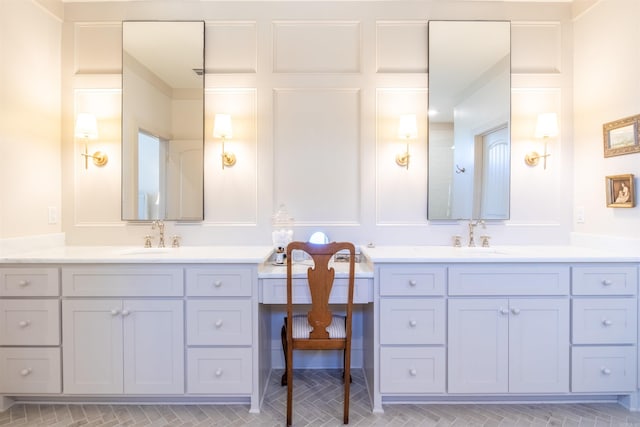 full bath featuring two vanities and a sink