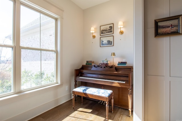 living area with wood finished floors and baseboards