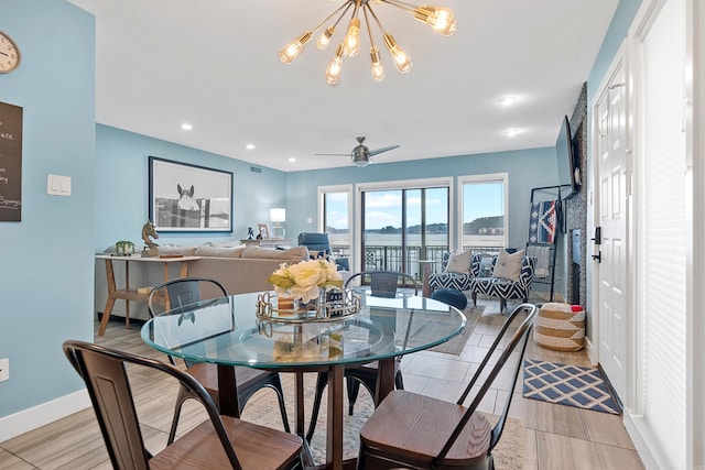 dining area with ceiling fan with notable chandelier, baseboards, and recessed lighting