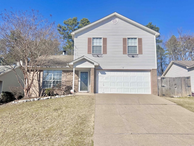 traditional home with a garage, concrete driveway, fence, a front lawn, and brick siding