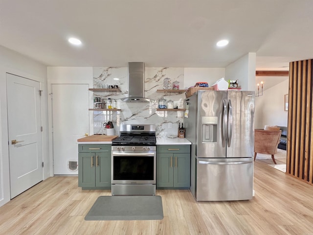 kitchen featuring appliances with stainless steel finishes, range hood, open shelves, light wood finished floors, and tasteful backsplash