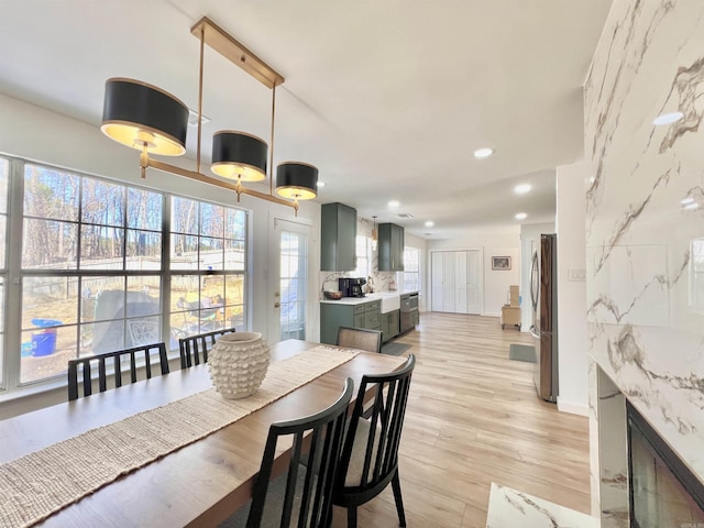 dining area with recessed lighting and light wood-style floors