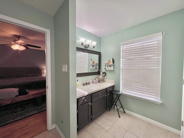 bathroom with a ceiling fan, tile patterned flooring, vanity, and baseboards