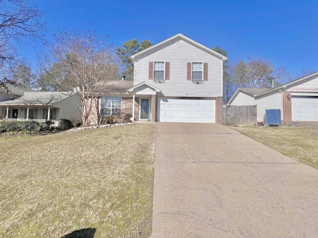 view of front of property with a garage, driveway, a front yard, and fence