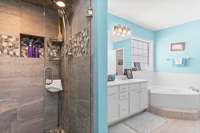 full bath featuring a garden tub, tile patterned flooring, a stall shower, and vanity