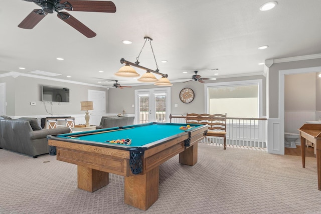 recreation room featuring a wainscoted wall, light carpet, and crown molding