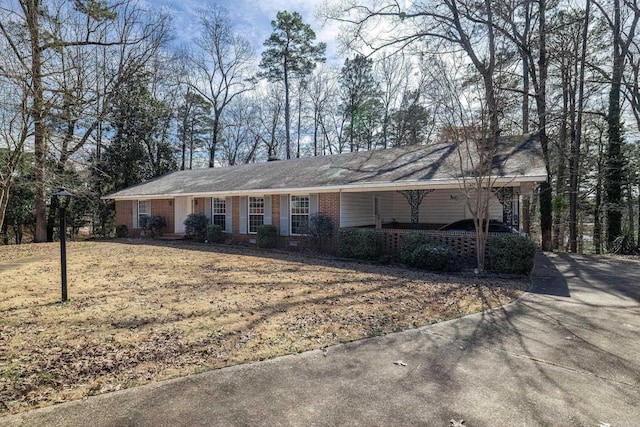 single story home with a front yard and brick siding