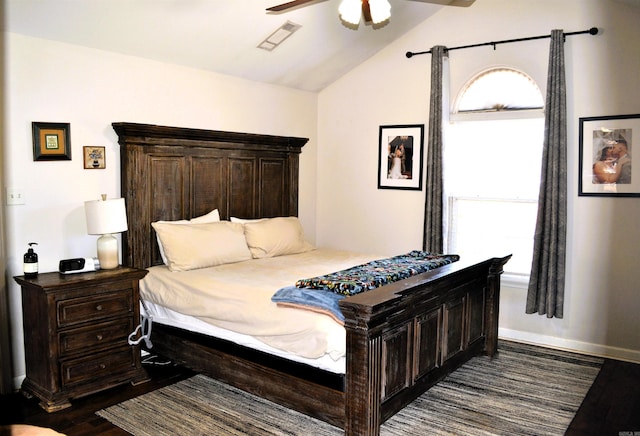 bedroom with ceiling fan, visible vents, baseboards, vaulted ceiling, and dark wood finished floors