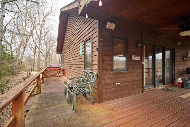 wooden deck featuring ceiling fan