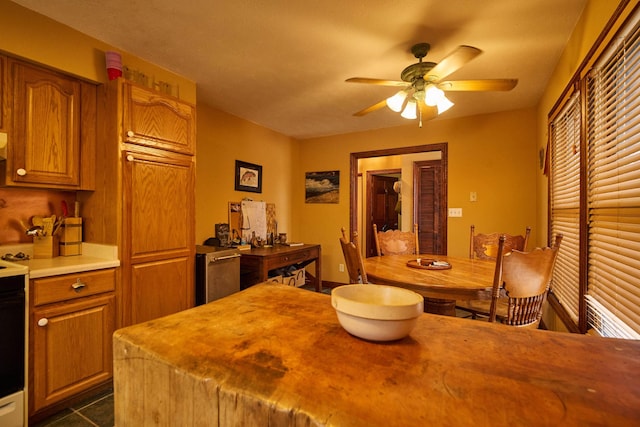 dining space featuring dark tile patterned flooring and ceiling fan