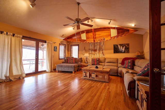 living room featuring light wood finished floors, lofted ceiling, ceiling fan, rail lighting, and french doors