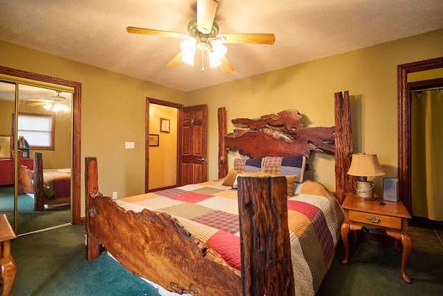 bedroom featuring ceiling fan, dark colored carpet, a closet, and a textured ceiling