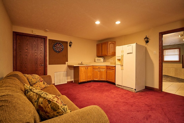 kitchen featuring white appliances, visible vents, carpet, light countertops, and recessed lighting