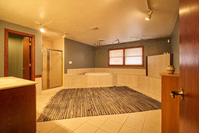 full bath with visible vents, a stall shower, vanity, a textured ceiling, and tile patterned flooring