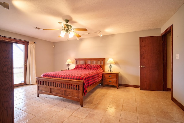 bedroom with access to exterior, baseboards, visible vents, and a textured ceiling