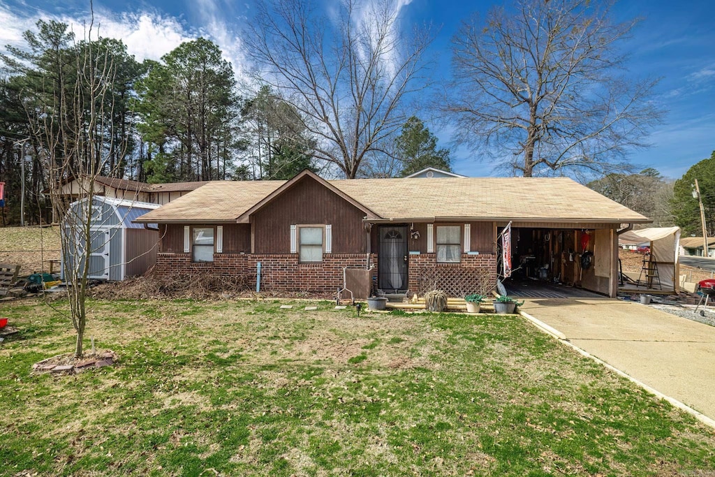 ranch-style house with a front lawn, concrete driveway, and brick siding