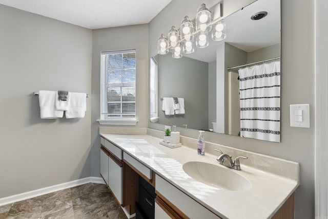 bathroom featuring a shower with curtain, vanity, and baseboards