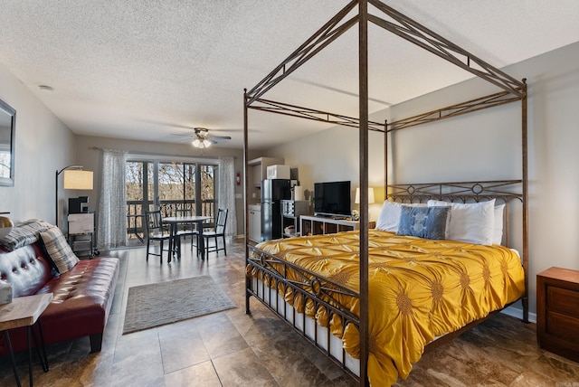 bedroom featuring access to exterior, freestanding refrigerator, and a textured ceiling