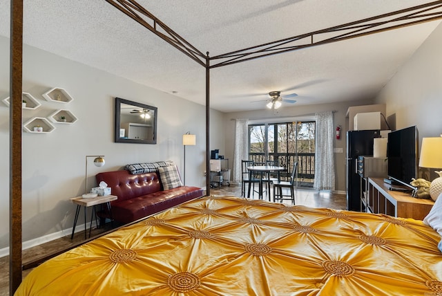 living room with ceiling fan, baseboards, and a textured ceiling