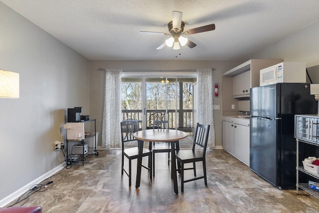 dining space featuring ceiling fan, baseboards, and a textured ceiling