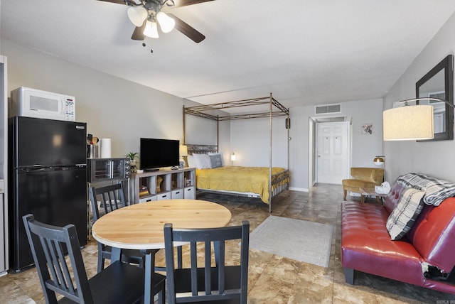 interior space featuring baseboards, visible vents, and a ceiling fan