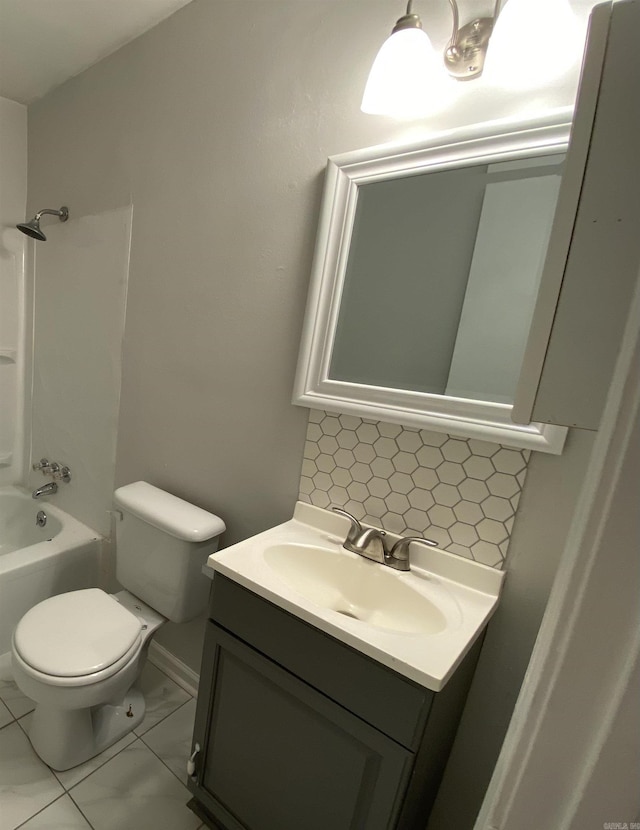 full bath with shower / bath combination, decorative backsplash, toilet, marble finish floor, and vanity