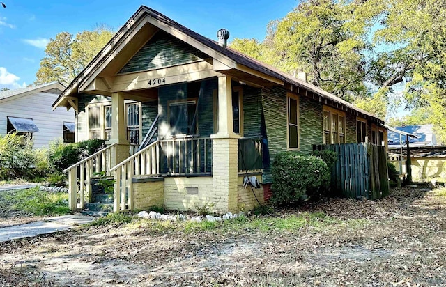 view of front of property with crawl space and brick siding