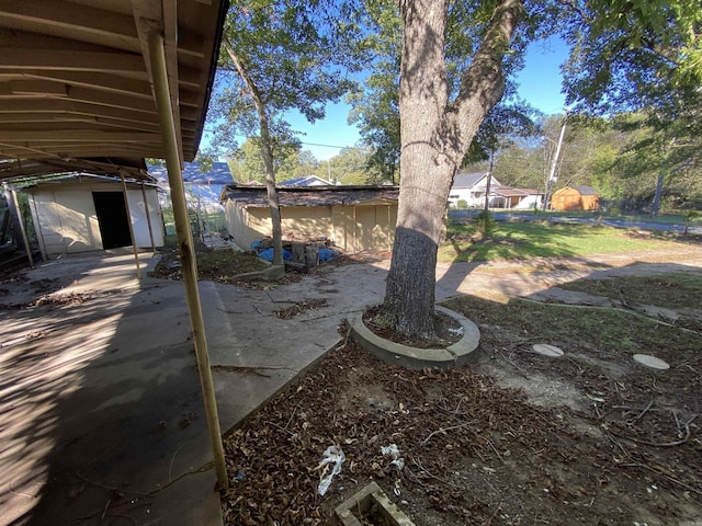 view of yard featuring an outdoor structure and fence