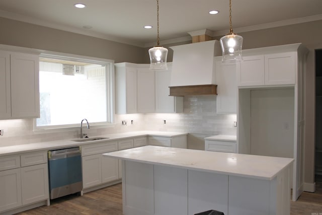 kitchen featuring white cabinets, a sink, custom exhaust hood, and stainless steel dishwasher