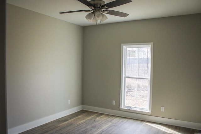 unfurnished room with a ceiling fan, baseboards, and wood finished floors