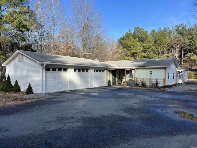 view of front of property featuring aphalt driveway and an attached garage