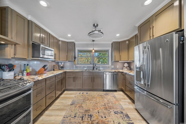 kitchen with decorative backsplash, light stone counters, stainless steel appliances, crown molding, and wall chimney range hood