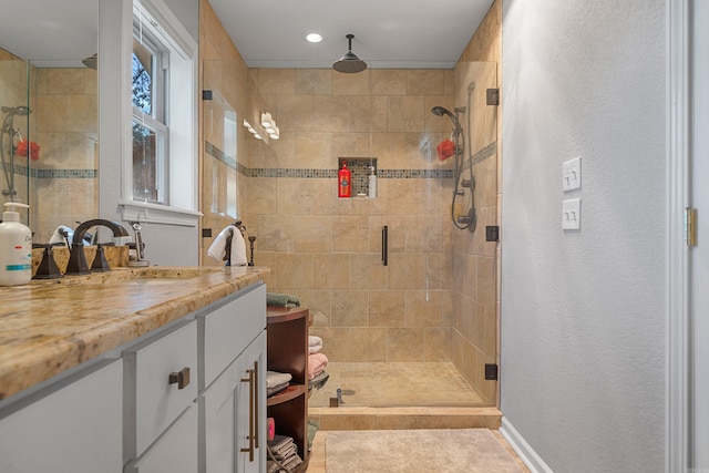 full bathroom featuring a stall shower, vanity, and baseboards